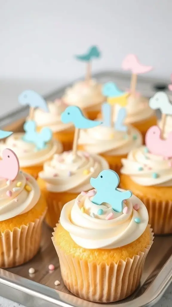 Vanilla cupcakes with white frosting and pastel baby-themed toppers