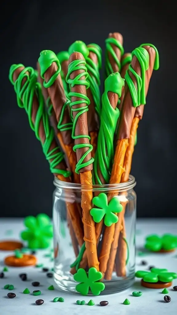A jar filled with chocolate-covered pretzel rods decorated with green icing and clover-shaped candies.