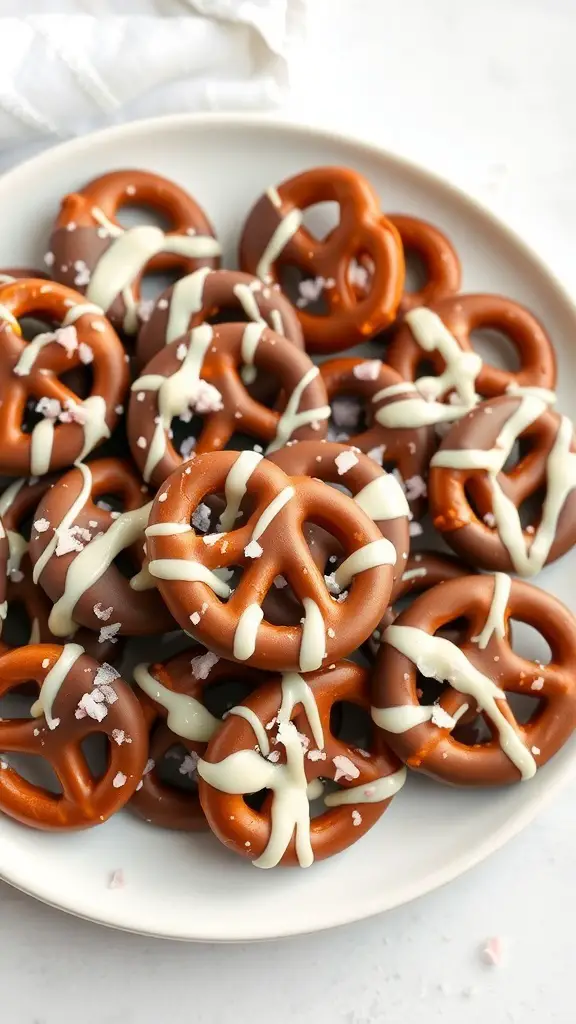 A plate of chocolate-covered pretzels drizzled with white chocolate and sprinkled with sea salt.